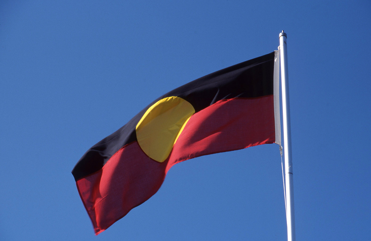 Australian Aboriginal flag blowing in a brisk breeze on a flagpole